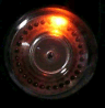 Figure 10 — 5a — A dekatron in operation, the glow parked on one cathode of its 0–9 ring — a whole decade counter in one envelope (animated). Photo: Dieter Waechter, via Wikimedia Commons (https://co…